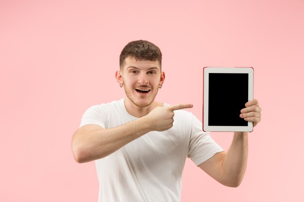 白で隔離の空白の画面でノートパソコンを指して笑顔の男の肖像画