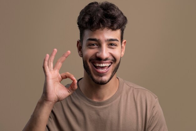 Portrait of smiling man showing okay sign