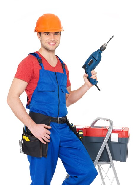 Portrait of smiling manual worker with tools isolated on white