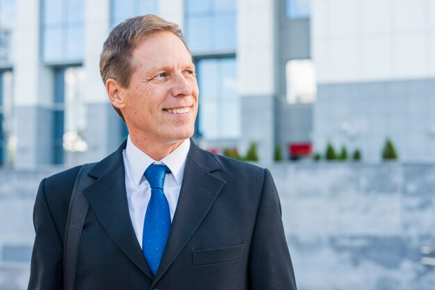 Portrait of a smiling mature businessman looking away