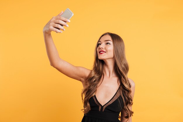 Portrait of a smiling pretty girl with long blond hair