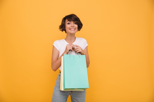 Portrait of a smiling satisfied woman holding shopping bags