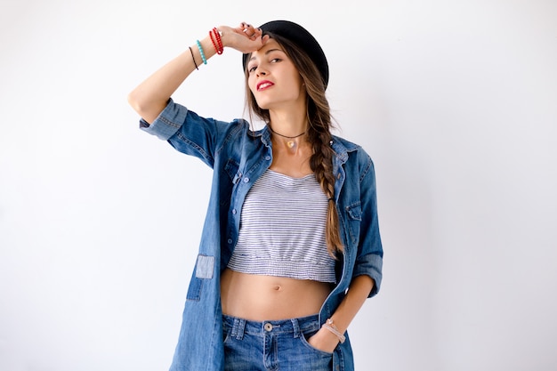 Portrait of smiling showing teeth young woman with hat