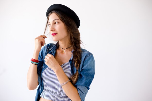 Portrait of smiling showing teeth young woman with hat