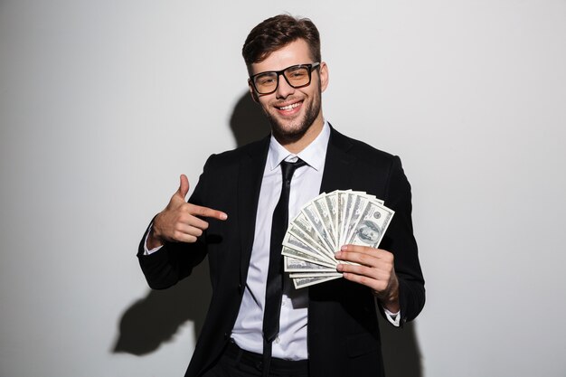 Portrait of a smiling successful man in suit and eyewear