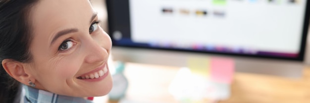 Portrait of smiling woman designer working at computer tablet for working in graphic editor