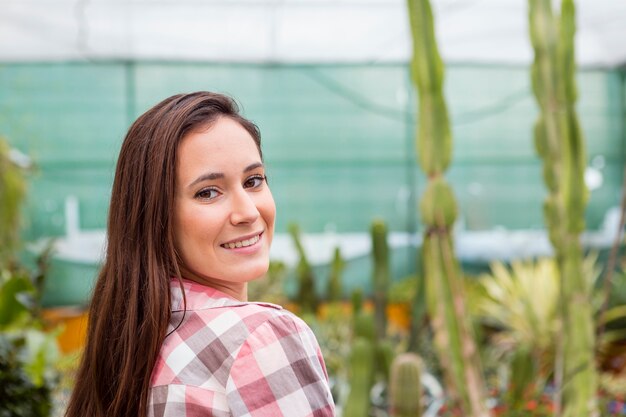 Portrait of smiling woman in greenhouse