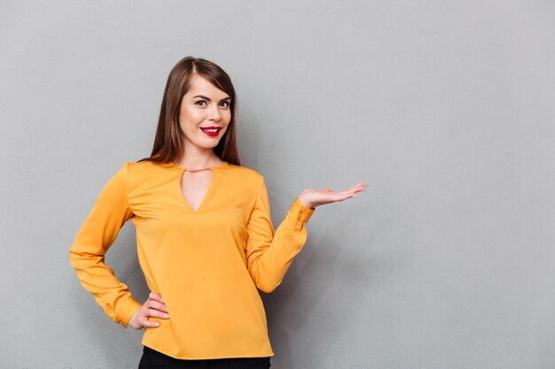 Portrait of a smiling woman holding copy space