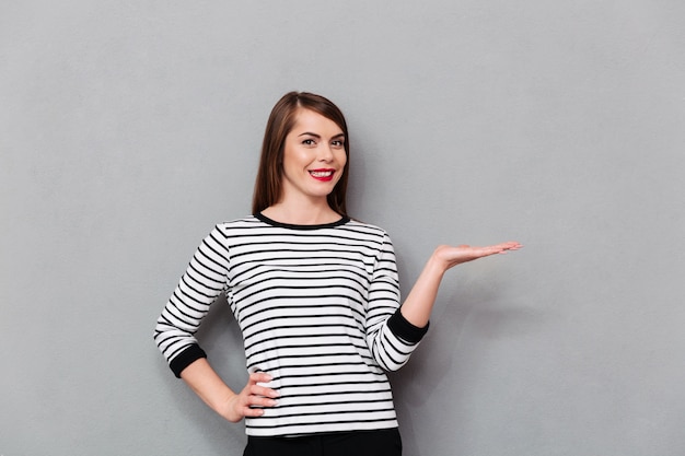 Portrait of a smiling woman holding copy space