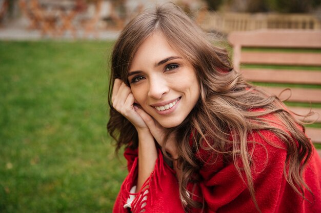 Portrait of a smiling woman resting at the park