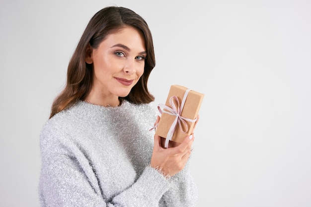 Portrait of smiling woman showing the gift