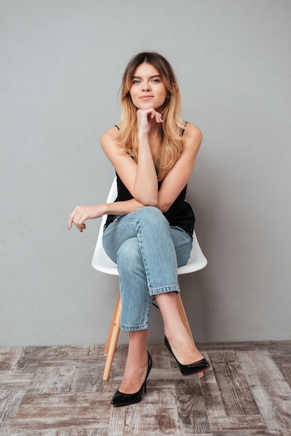 Portrait of a smiling woman sitting on a chair