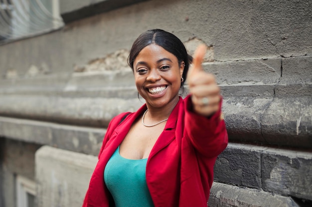 portrait of a smiling  woman with thumb up