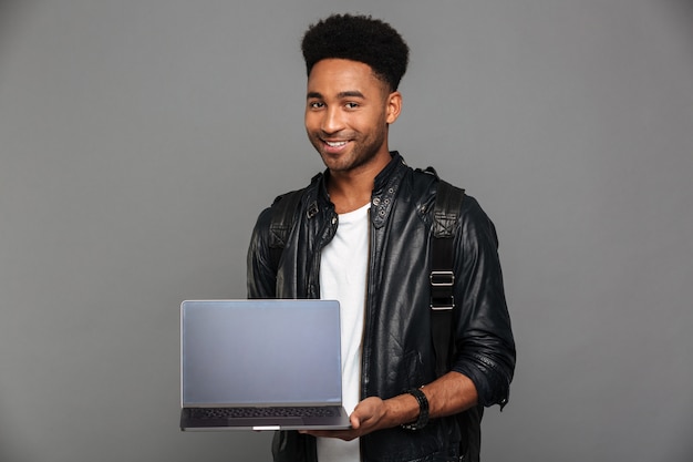 Portrait of a smiling young african man in leather jacket