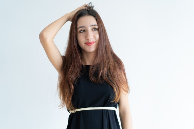 Portrait of smiling young Asian woman scratching head