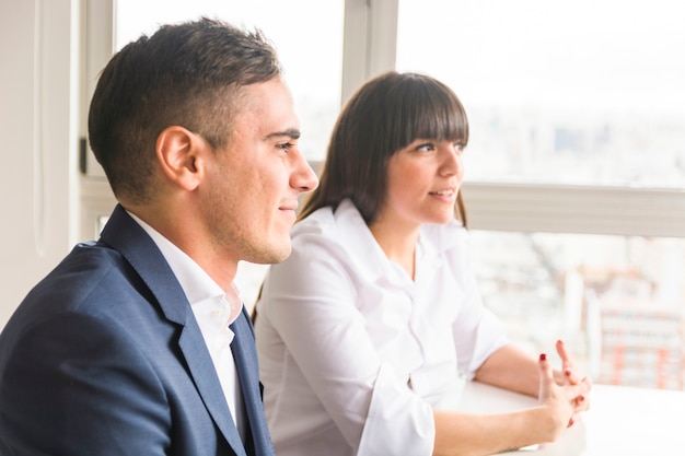 Portrait of smiling young business couple in the office