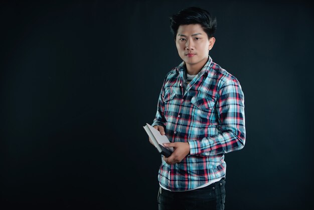 Portrait of smiling young college student with books