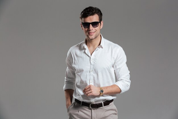 Portrait of a smiling young man dressed in white shirt