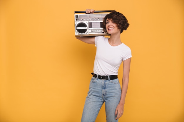 Portrait of a smiling young woman holding record player