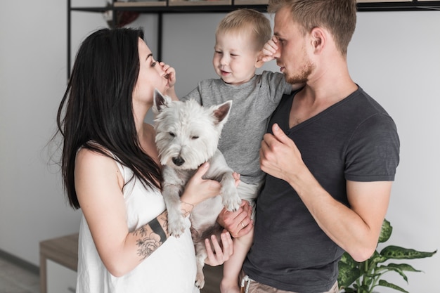 Free photo portrait of son rubbing their parent's nose at home