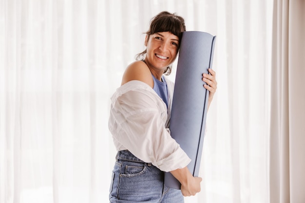 Portrait sport woman smiling at camera at home