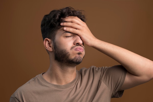 Portrait of stressed man touching his forehead
