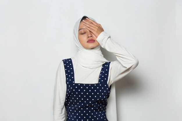 Portrait of stressed sick muslim woman with headache ill woman suffers from vertigo dizziness