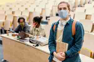 Free photo portrait of student wearing medical mask