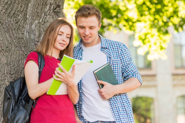 Free photo portrait of students next to tree