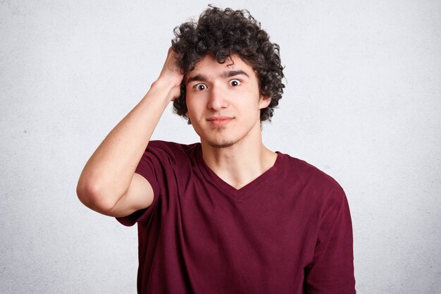 Portrait of stunned handsome male has surprised expression