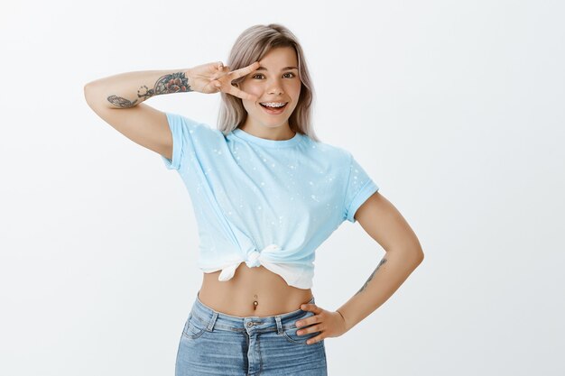 Portrait of stylish good-looking blonde girl posing in the studio