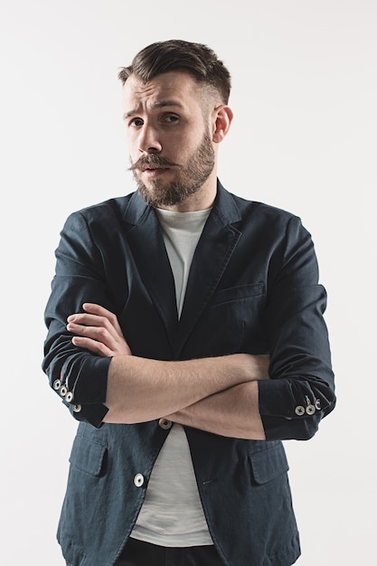 Portrait of stylish handsome young man standing against white. Man wearing jacket