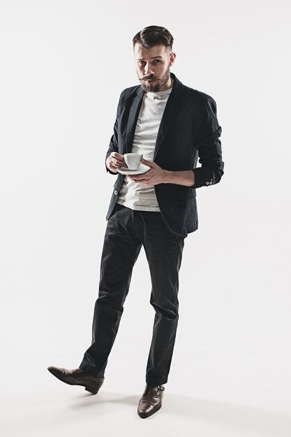 Portrait of stylish handsome young man with cup of coffee