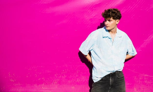 Portrait of a stylish man with pink background