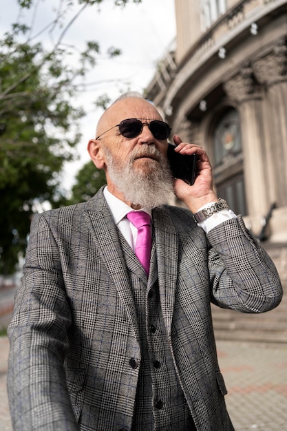 Portrait of stylish senior man speaking on the phone