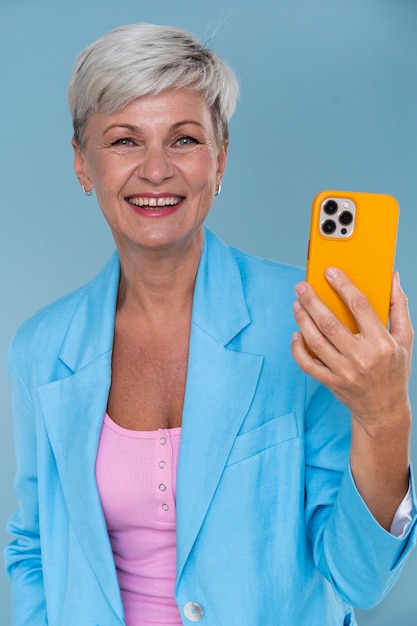 Portrait of stylish senior woman holding her phone