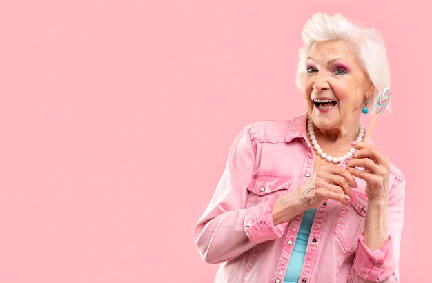 Portrait of stylish senior woman in pink