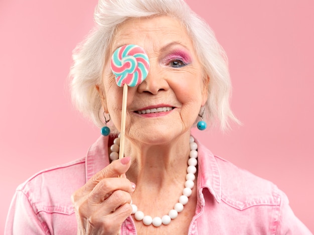 Portrait of stylish senior woman in pink