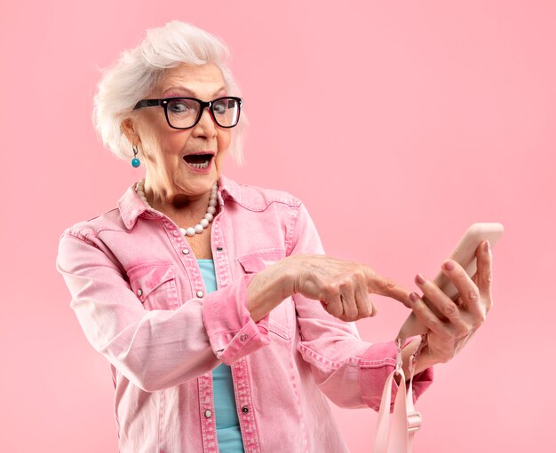 Portrait of stylish senior woman in pink