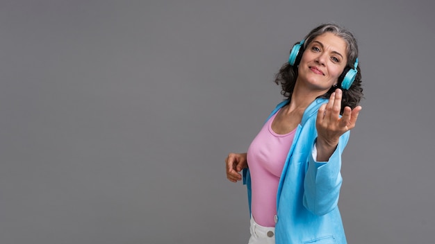 Portrait of stylish senior woman with a pair of headphones