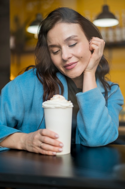 Portrait of stylish woman holding hot chocolate