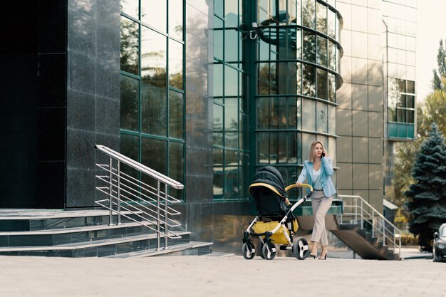 Portrait of a successful business woman in blue suit with baby