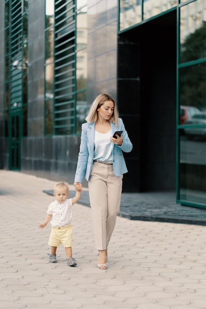 Portrait of a successful business woman in blue suit with baby