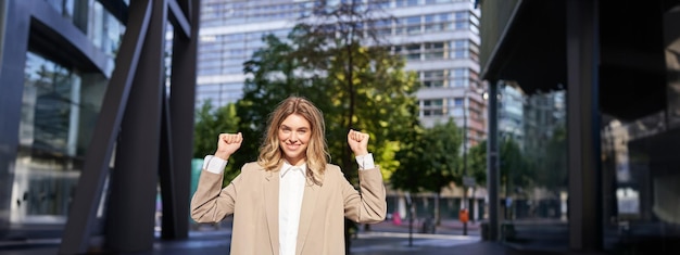 Free photo portrait of successful business woman young corporate woman celebrating victory achievement