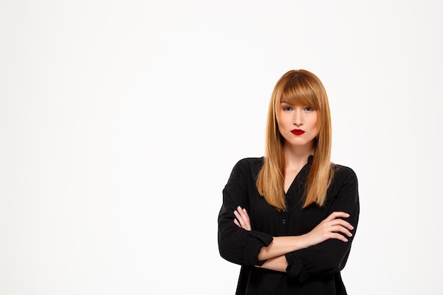 Portrait of successful businesswoMan standing over white wall Copy space