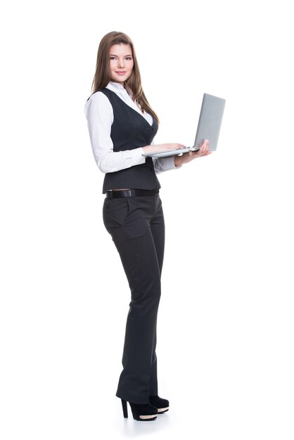 Portrait successful young business woman holding laptop in full length - isolated on white.