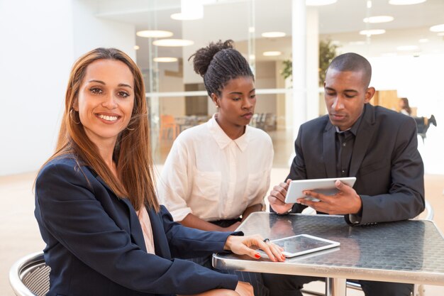 Portrait of successful young businesswoman with colleagues