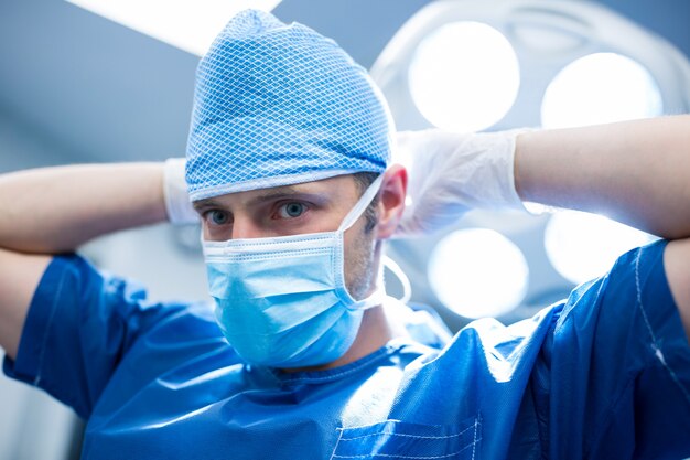 Portrait of surgeon wearing mask in operation room