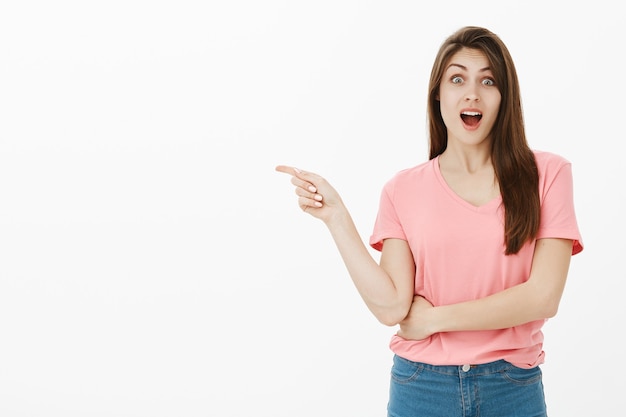 Portrait of surprised brunette woman posing in the studio