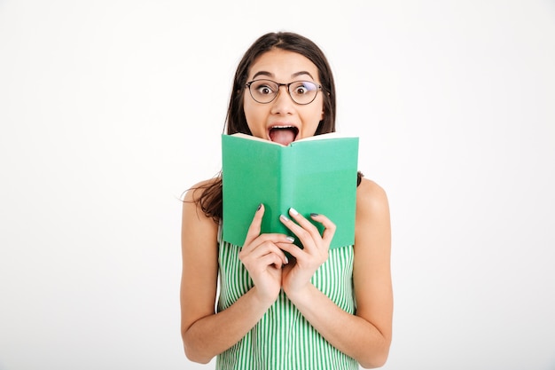 Portrait of a surprised girl in dress and eyeglasses